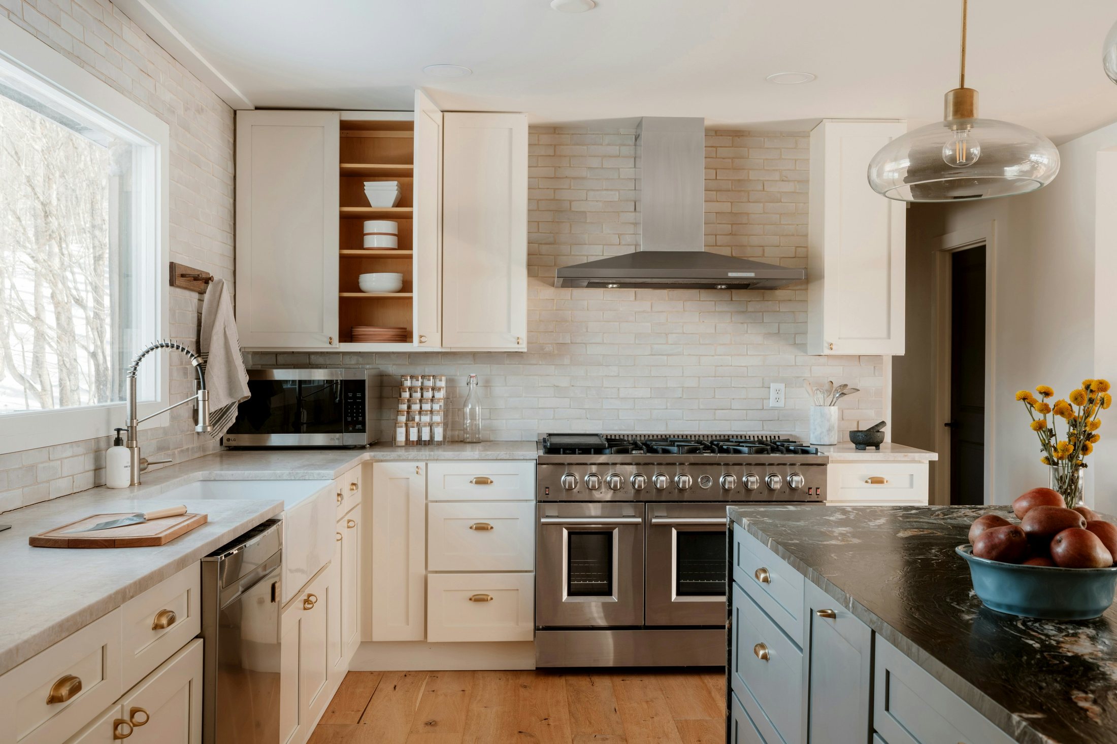 Bright finished kitchen with white cabinets and contrasting island