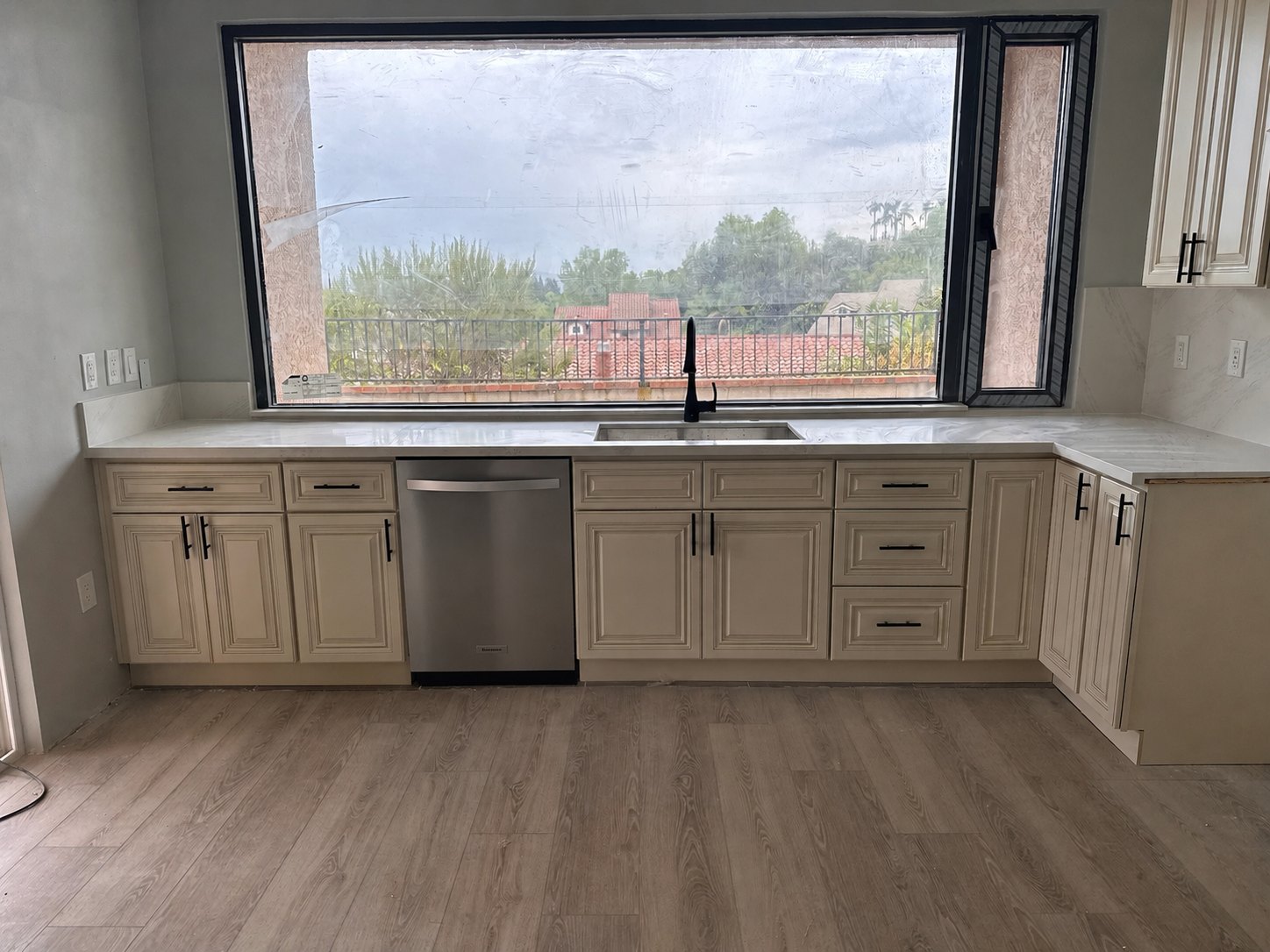 Classic Antique White cabinets around a large kitchen window